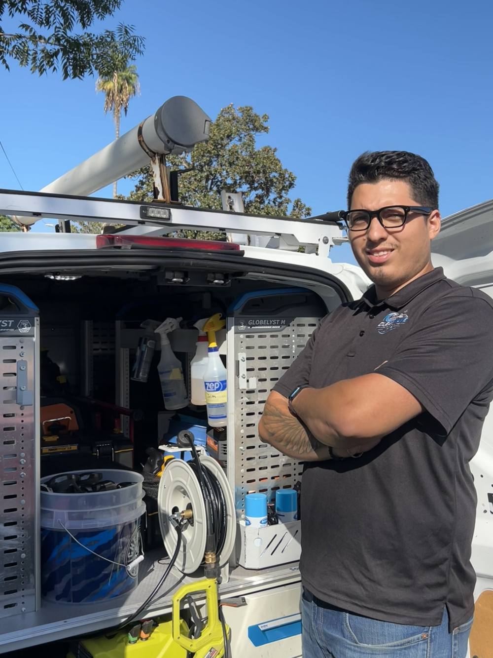 Ismael Olea, owner of Clean Wave Mobile Detailing, standing next to his detailing van